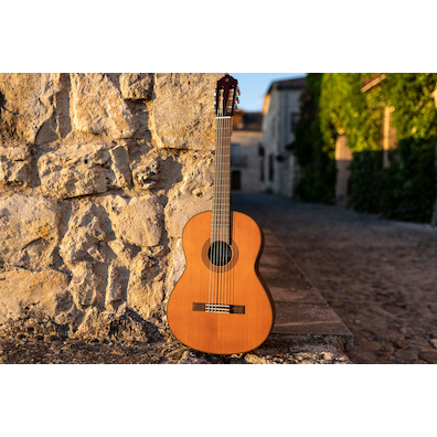CGX122MC guitar leaning on a stone wall in the street of Pedraza, Segovia during sunset