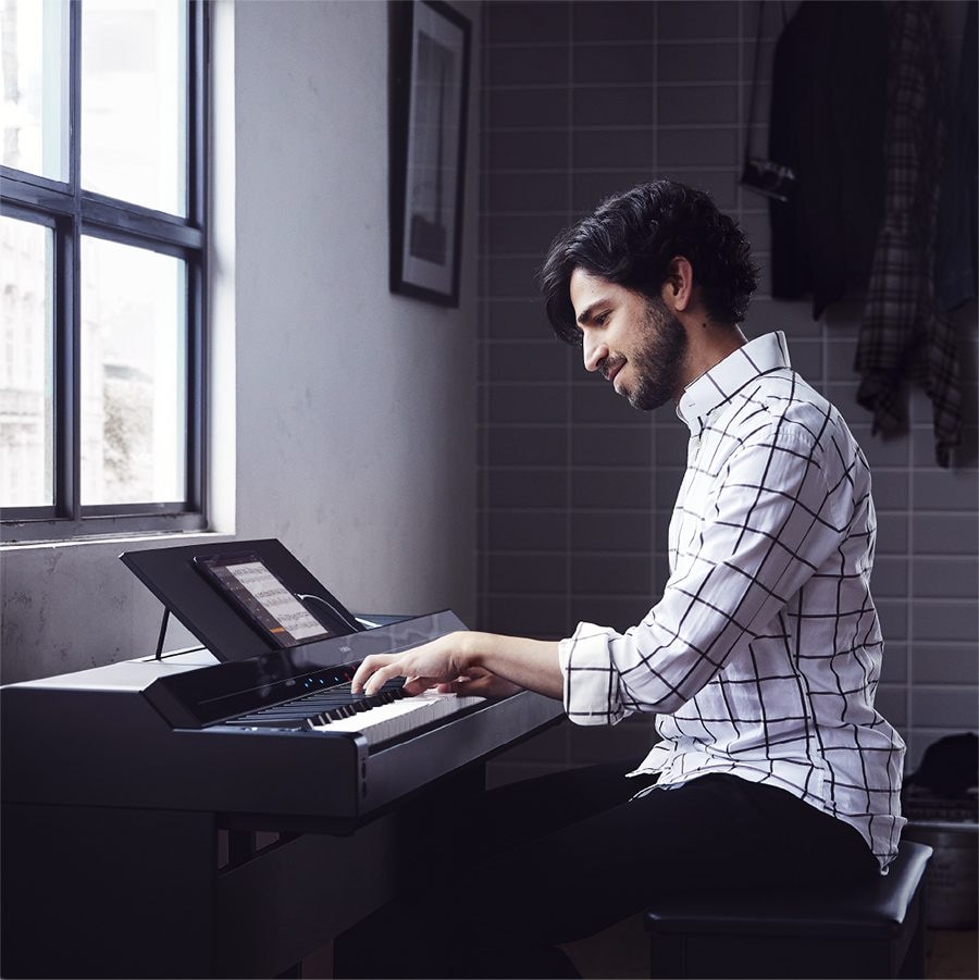 A person playing a Yamaha P-S500 Portable Digital Smart Piano