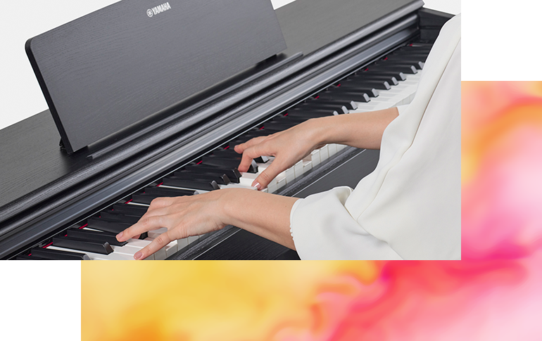 ARIUS YDP-105 88-Key Black Digital Piano - Showing a person playing the piano