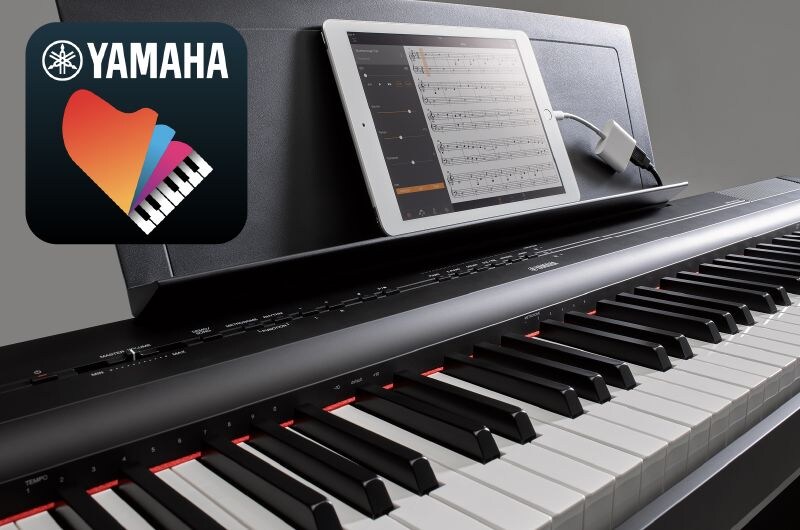 A photo of the Yamaha “Smart Pianist” app icon, together with a tablet displaying a musical score …