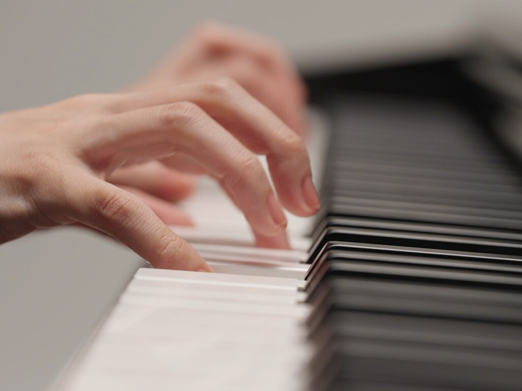 Hands playing the Graded Hammer Standard (GHS) keyboard