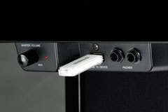 A close-up view of a digital piano's lower control panel and a usb flash drive plugged into the usb port