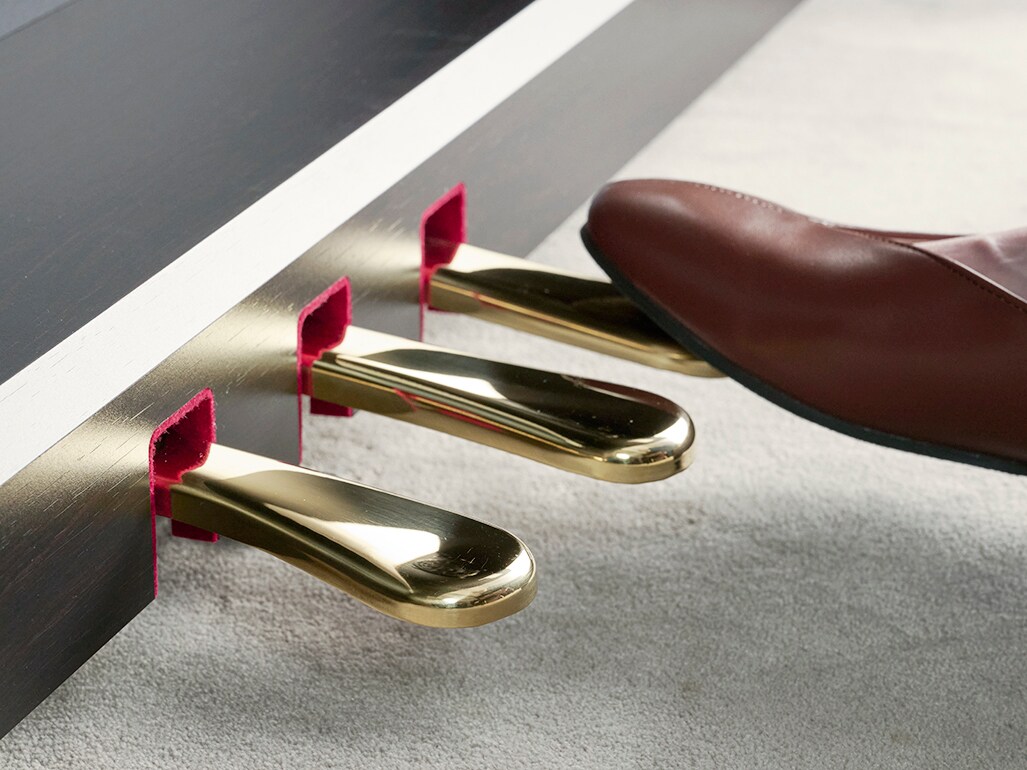 A right foot pressing the damper pedal