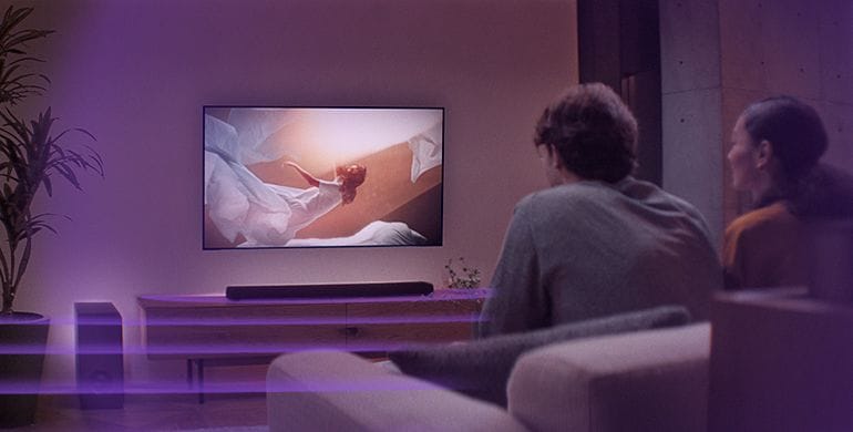 Image of couple watching TV with sound bar