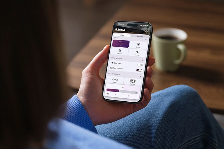 Person using the Sound Bar Remote app on a smartphone