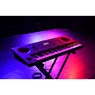 A keyboard on a stand under stage lighting