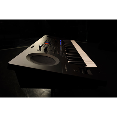 A keyboard on a stand under stage lighting