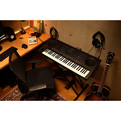 A home music workspace with a computer and keyboard