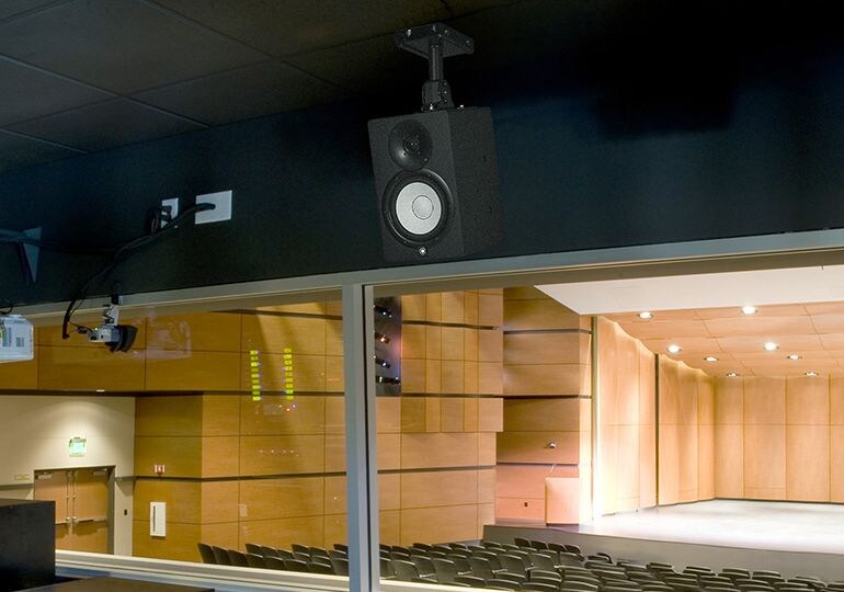 HS speaker attached to a bracket connected to a celling 