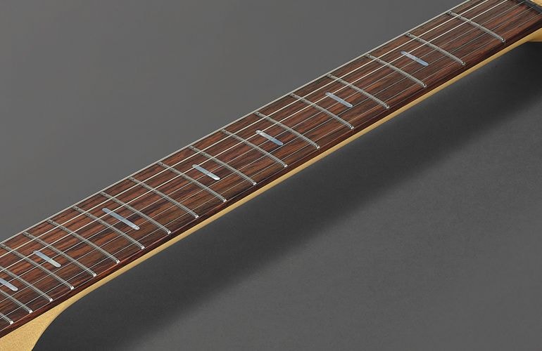 Closeup of stainless steel frets on rosewood Pacifica fingerboard.