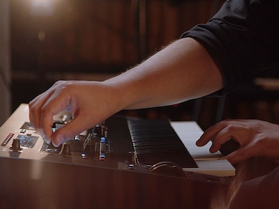 close up view of hand using controls on the yamaha montage m synthesizer