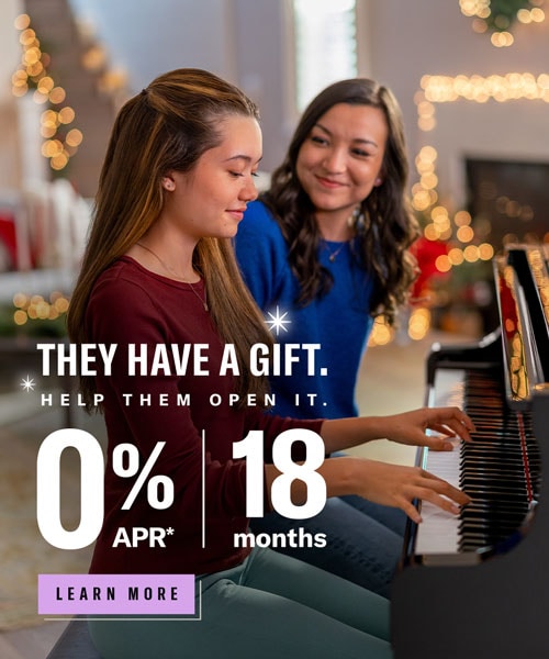 happy mother with daughter playing the piano 