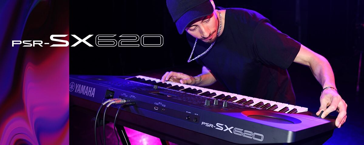 Performer playing a PSR-SX620 keyboard on stage.