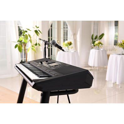Yamaha Arranger Workstation PSR-SX720+ with microphone stand at a party venue