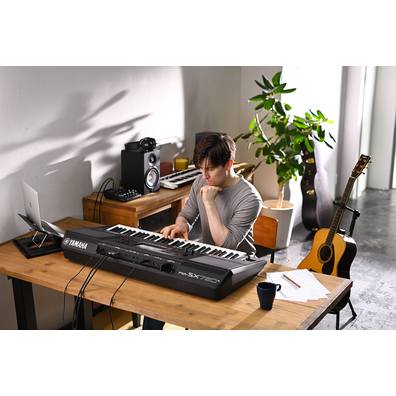 Photo of a person playing Yamaha Arranger Workstation PSR-SX720+