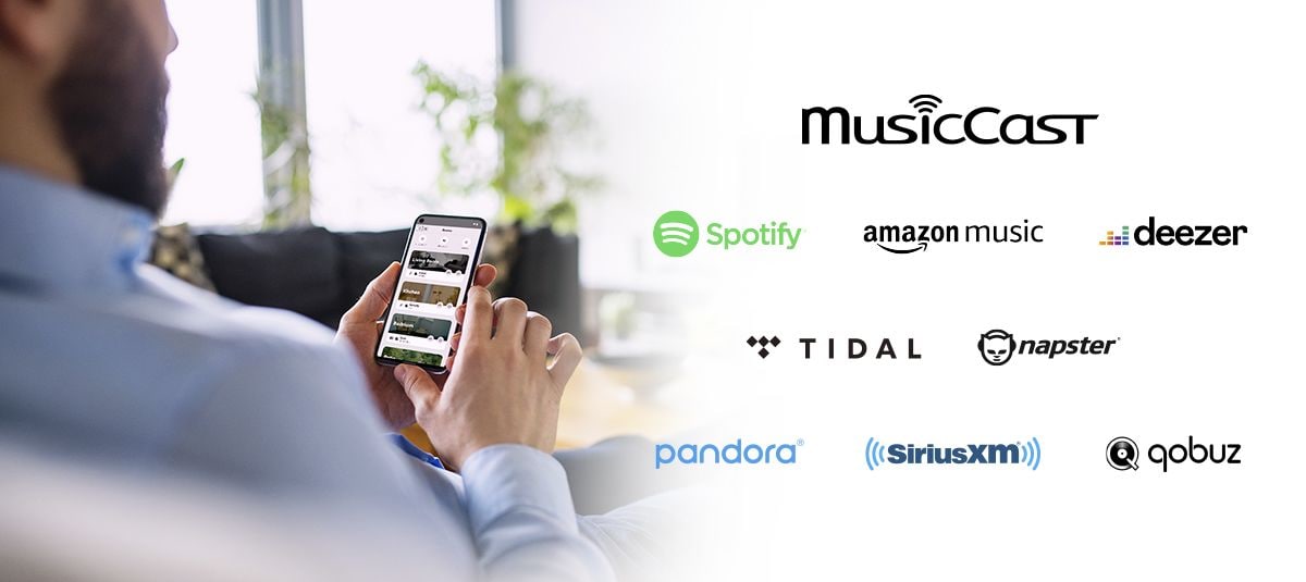 Man holding phone and icons of various music streaming services.