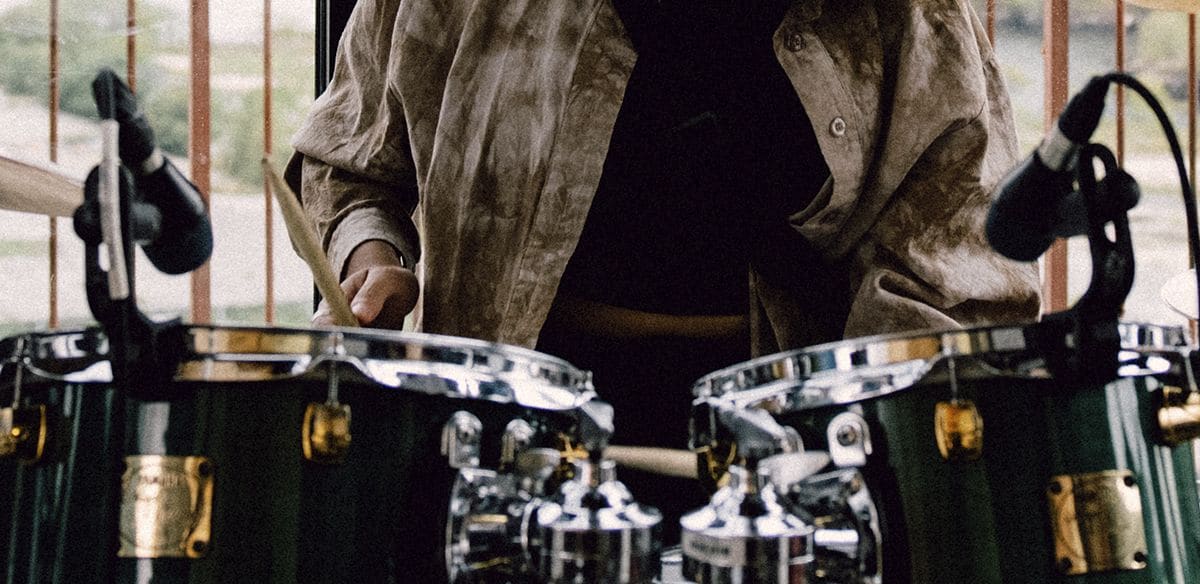 Person playing a Yamaha drum set.