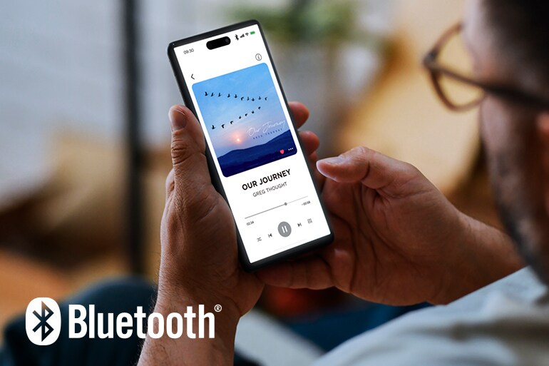 The Bluetooth logo and a man using a smartphone for music playback.