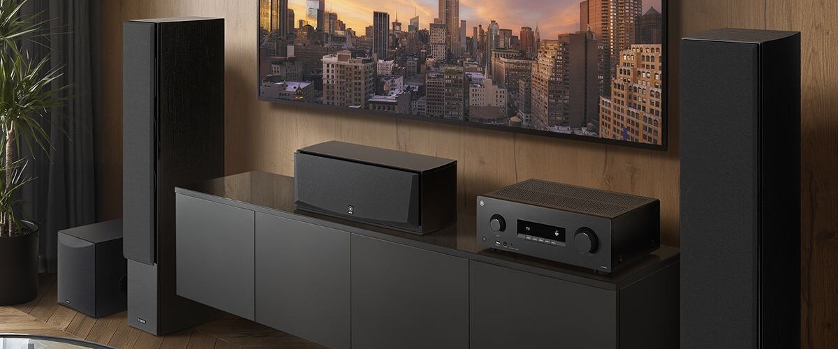 The RX500A, a center speaker, front speakers and a subwoofer in a room.