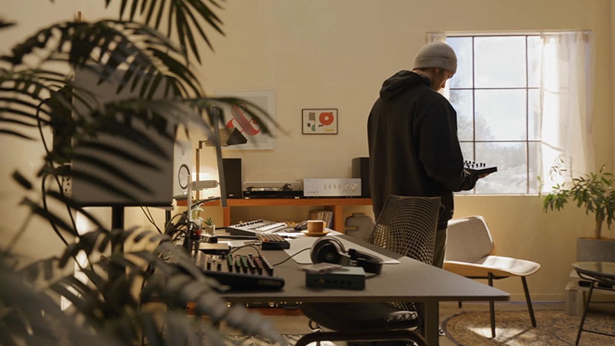 Person holding the SEQTRAK inside a home studio.