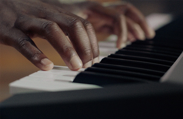 Hand playing a keyboard