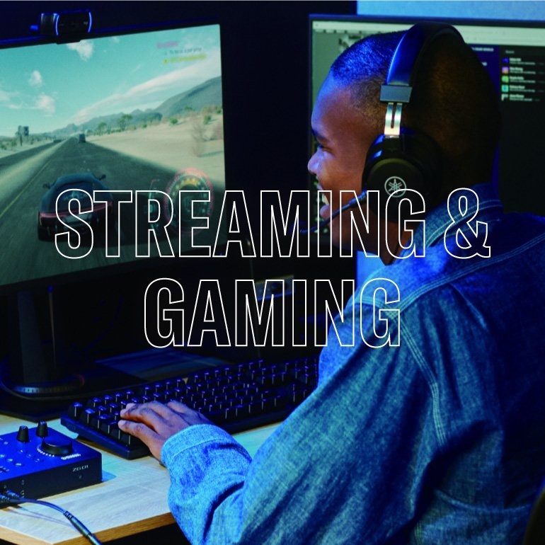 Image showing a man playing game using Yamaha ZG01 Gaming Mixer and wearing Yamaha YH-G01 gaming headset