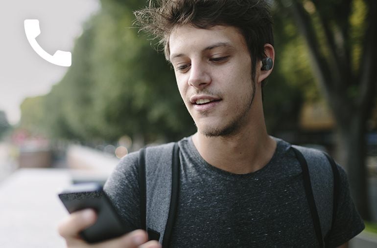 Image of a man looking at the phone wearing TW-E7B earbud 