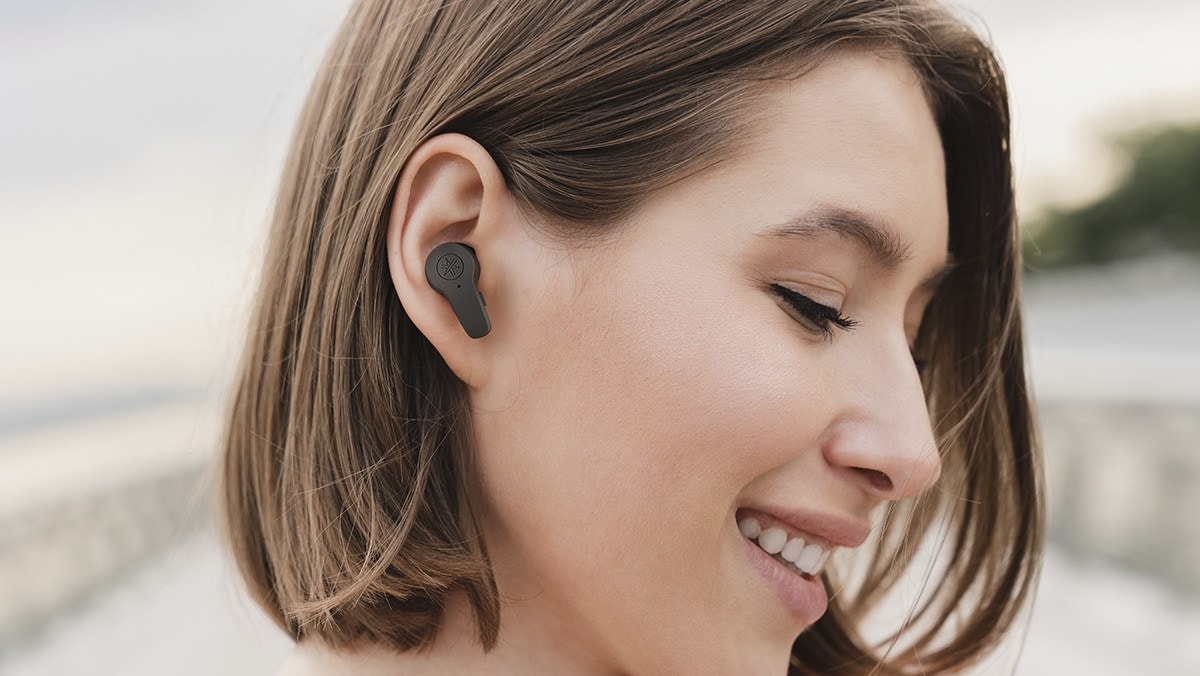 Side profile of person using the TWEF3A earbuds.