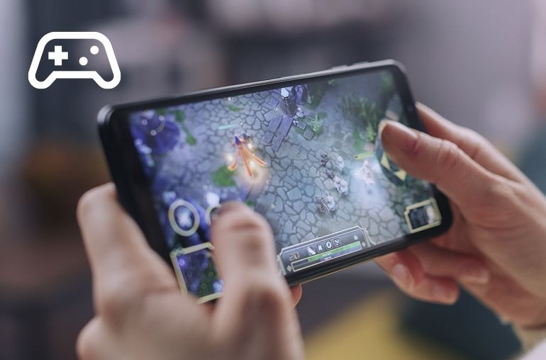 Image of someone holding a mobile and playing a game