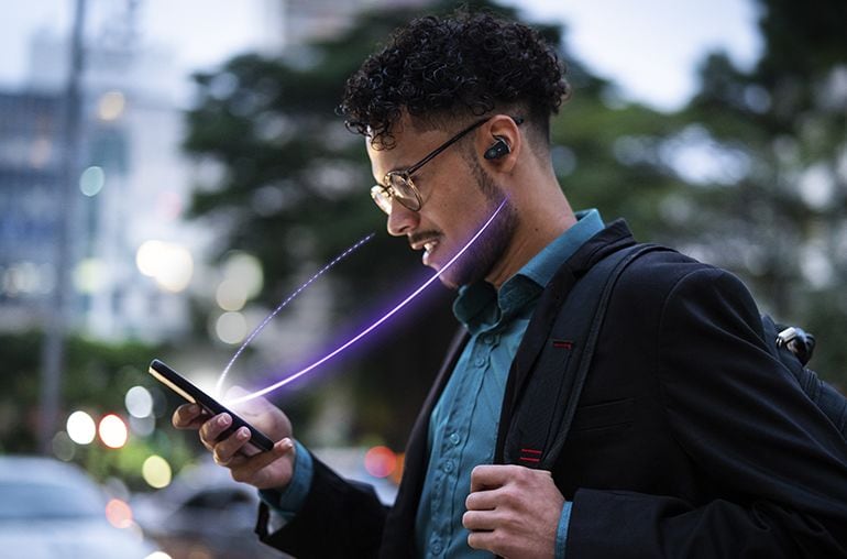 Image of a man looking at the phone wearing TW-ES5A earbud