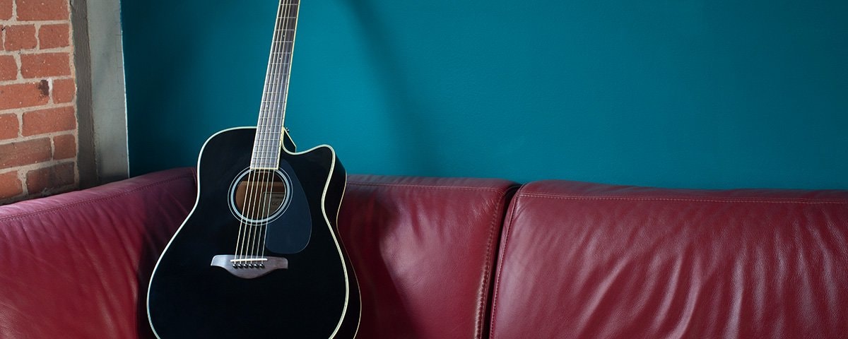 Guitar kept on the sofa