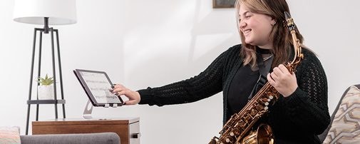 image of a female holding Yamaha Saxohphone