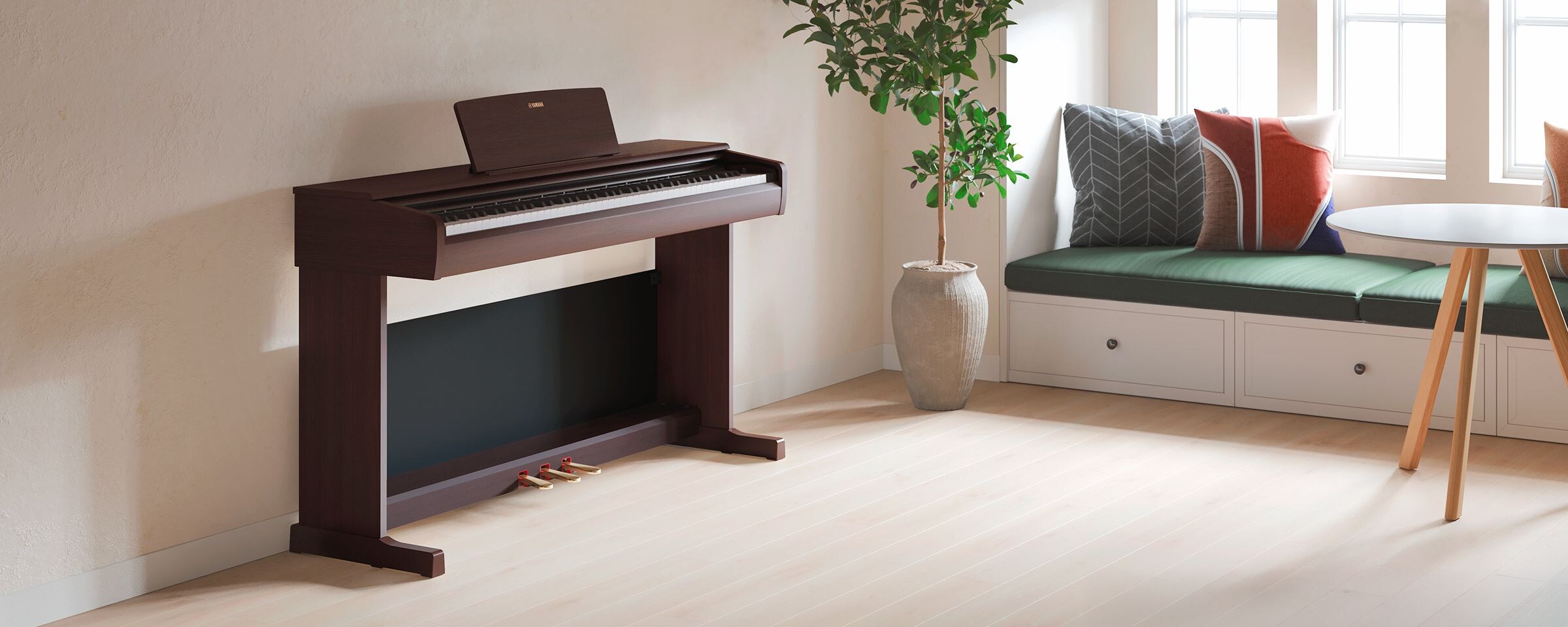 A living room featuring an ARIUS piano with houseplants and a sofa, harmoniously integrated with the interior