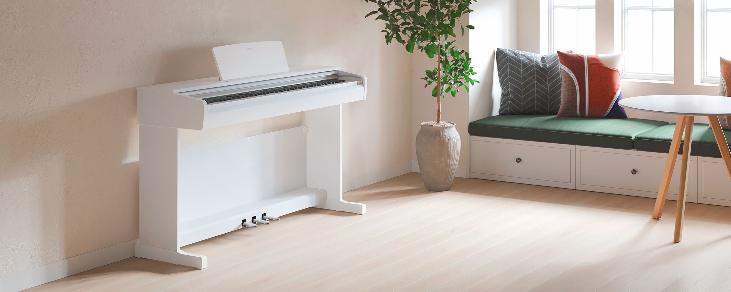 A living room featuring a white  ARIUS piano with houseplants and a sofa, harmoniously integrated with the interior