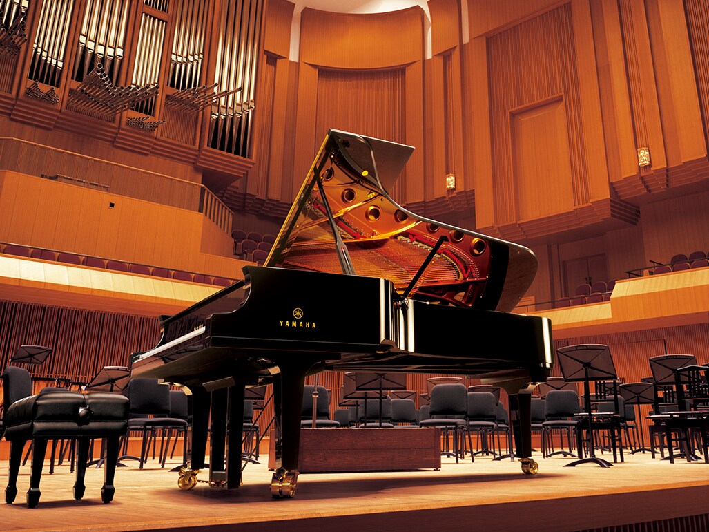Yamaha CFX concert grand piano on a concert hall stage