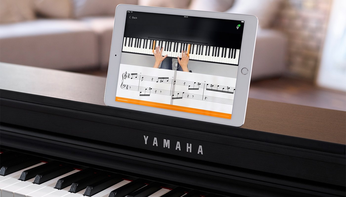 image flowkey app on ipad which is placed on the piano