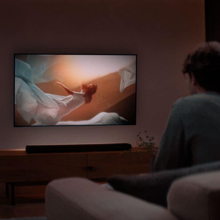 Image of a man watching TV with Yamaha TRUE X BAR 40A