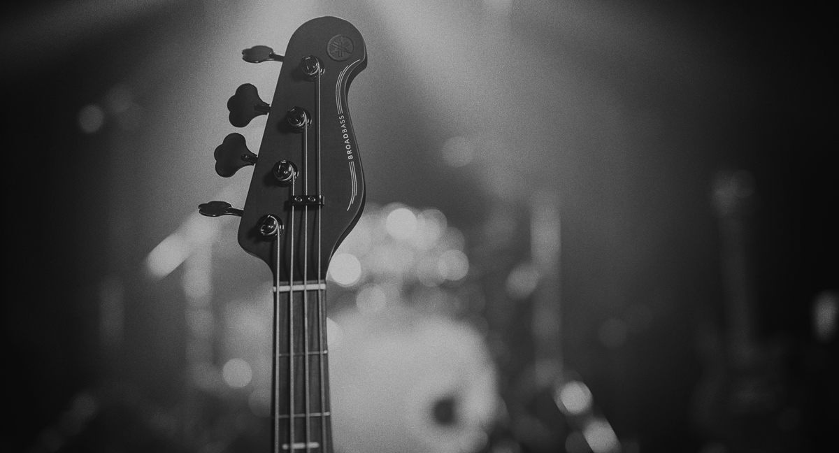 Close-up of BB headstock with soft focus on a drumkit in the background