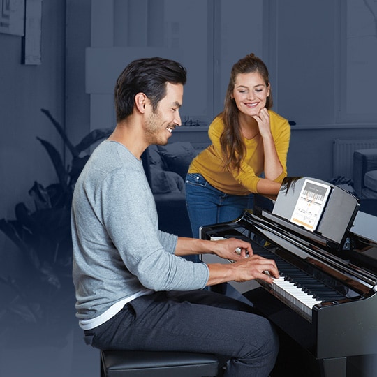 Image showing man is playing piano and a woman is standing next to him