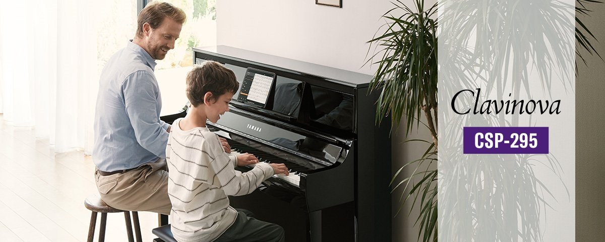 Man teaching kid on CSP-295 piano angle view