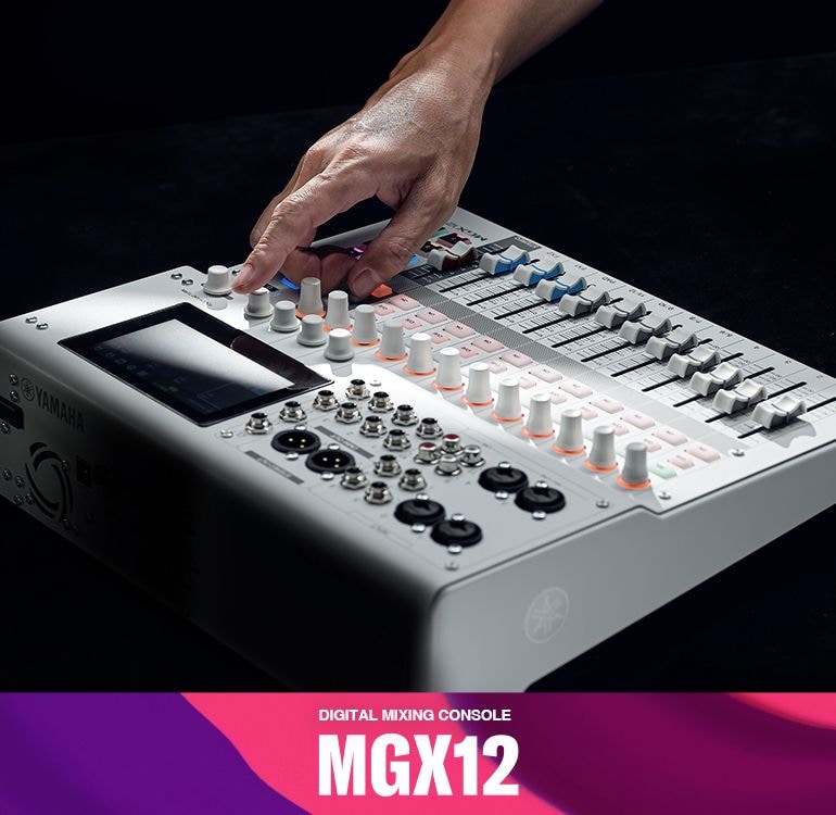Hand dialing the knob of  Yamaha 18-Channel Digital Mixing Console MGX12