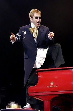 Elton Stands on the Piano