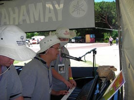 Three musicians playing a keyboard