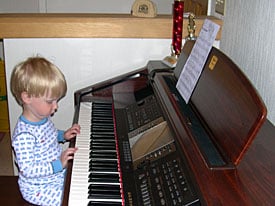Child playing Yamaha Clavinova