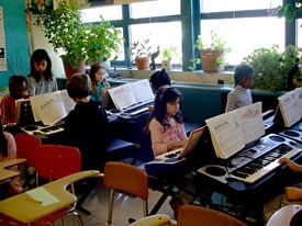Schoolchildren play Yamaha keyboards