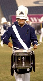 A Bluecoat marching band member plays a Yamaha snare