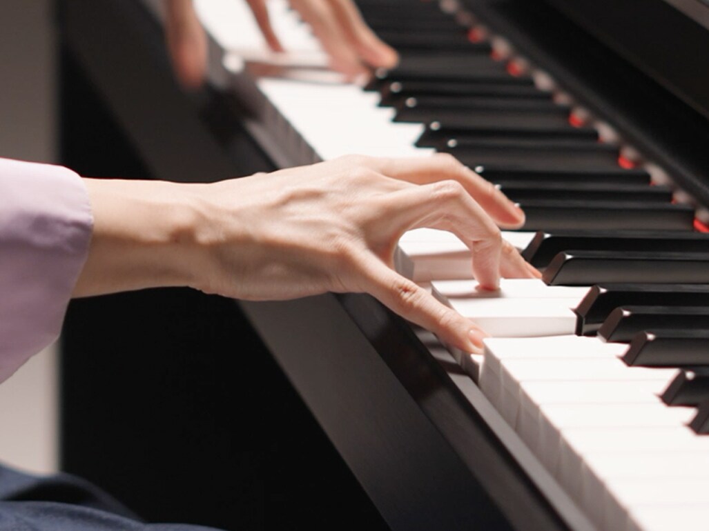 Hands playing the Graded Hammer Standard (GHS) keyboard