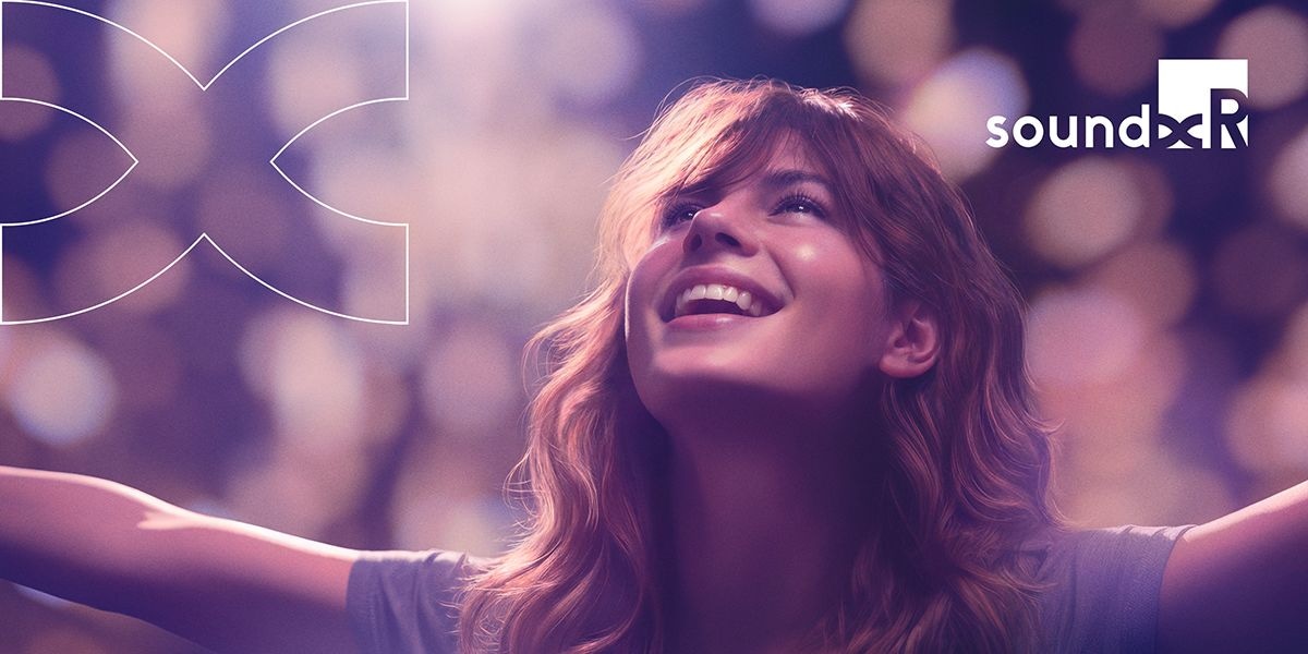 A smiling young woman looks upward with her arms open wide and the Sound Rx logo to the right of her.