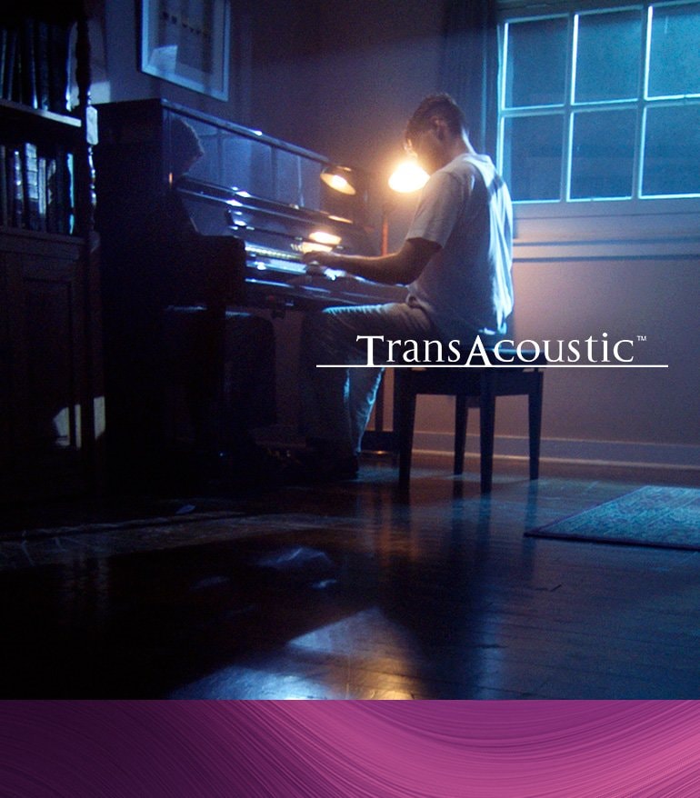 Lifestyle image of a man playing Transacoustic TA3 piano - Mobile